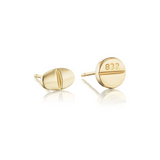 Mad Fine mismatched pair of solid 14k gold stud earrings, one oval and one round, inspired by prescription pills.
