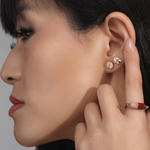 Mad Fine mismatched 14k gold stud earrings inspired by prescription pills, one oval with a line, the other round with "832" engraving.